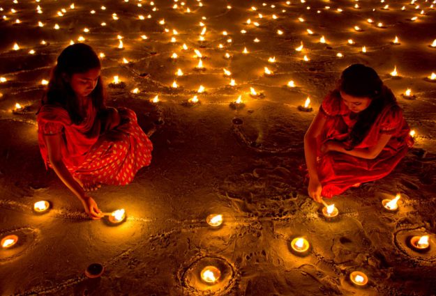 People in India lighting candles as part of Diwali festival celebrations